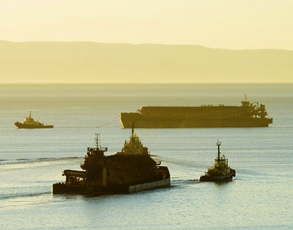 The barges used to load the Cape Vessels are pictured being towed to and from the MV Cape Monemvasia. Image: http://www.arrium.com/